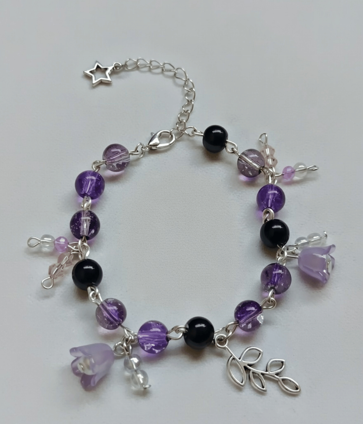 Charmful crystal bracelet with flower and leaf charms