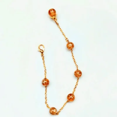 Cracked golden beads bracelet with gold chain by Stay Decorative