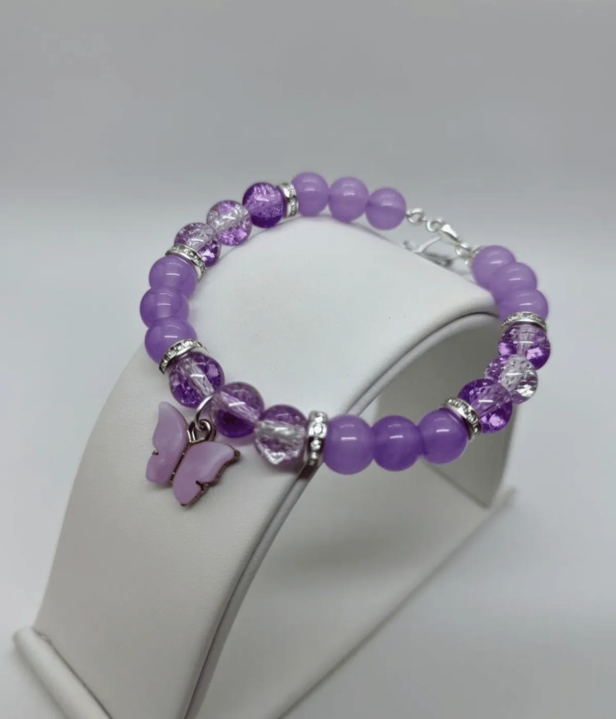 Close view of purple gemstone beads and crystal separators in butterfly bracelet