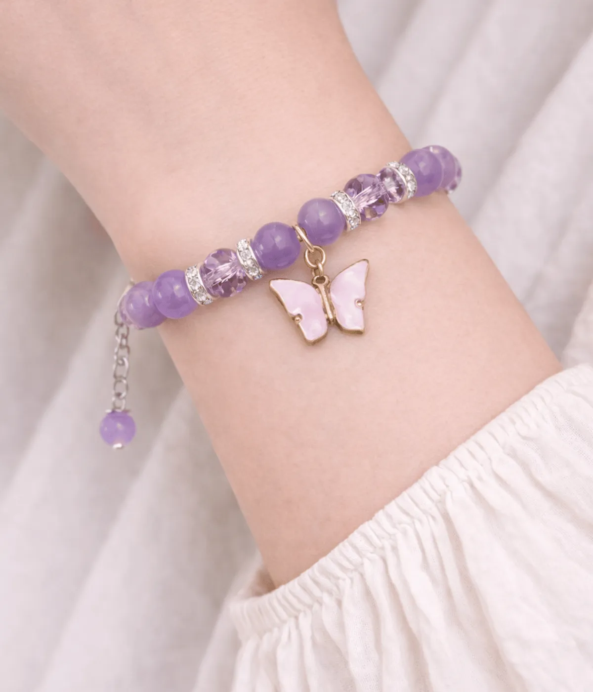 Purple gemstone butterfly bracelet worn on wrist showing adjustable fit